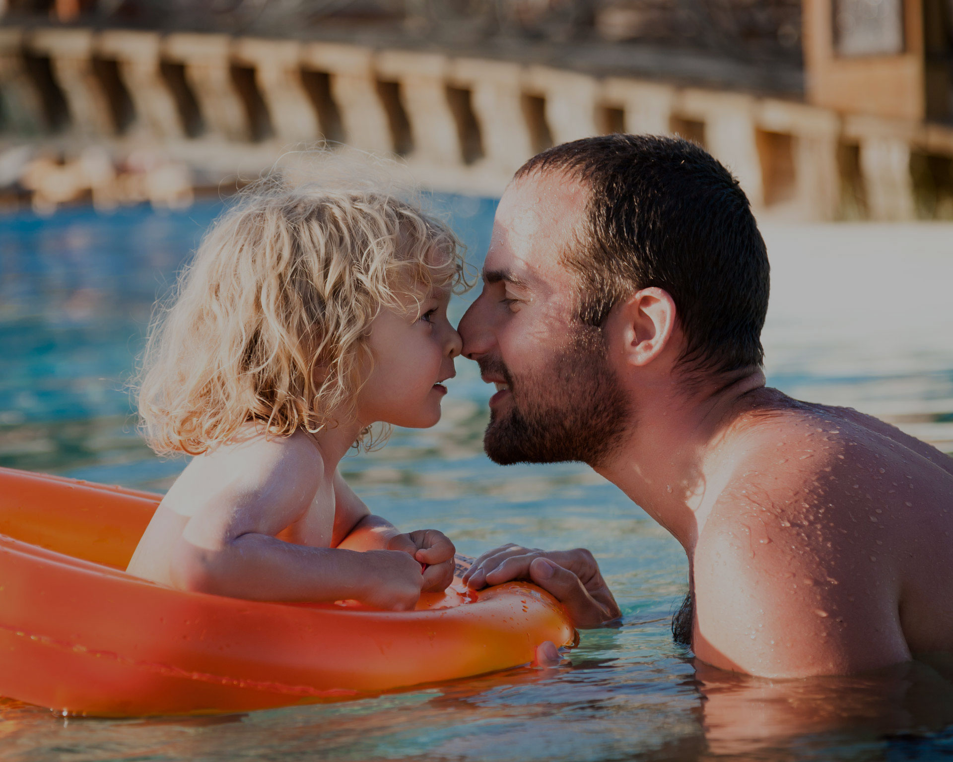 Father and child swimming in pool